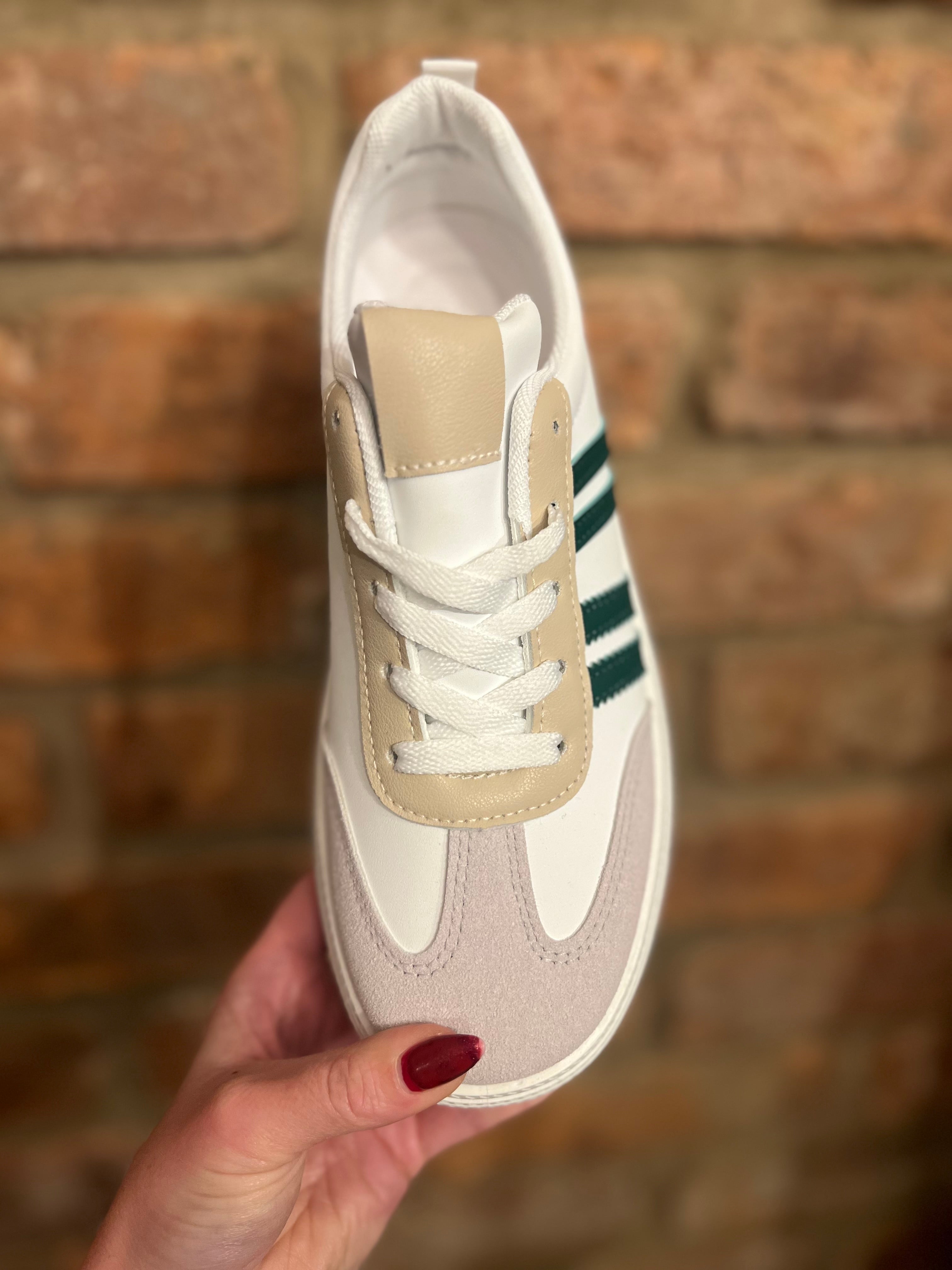 White trainers with three green stripes