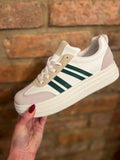 White trainers with three green stripes