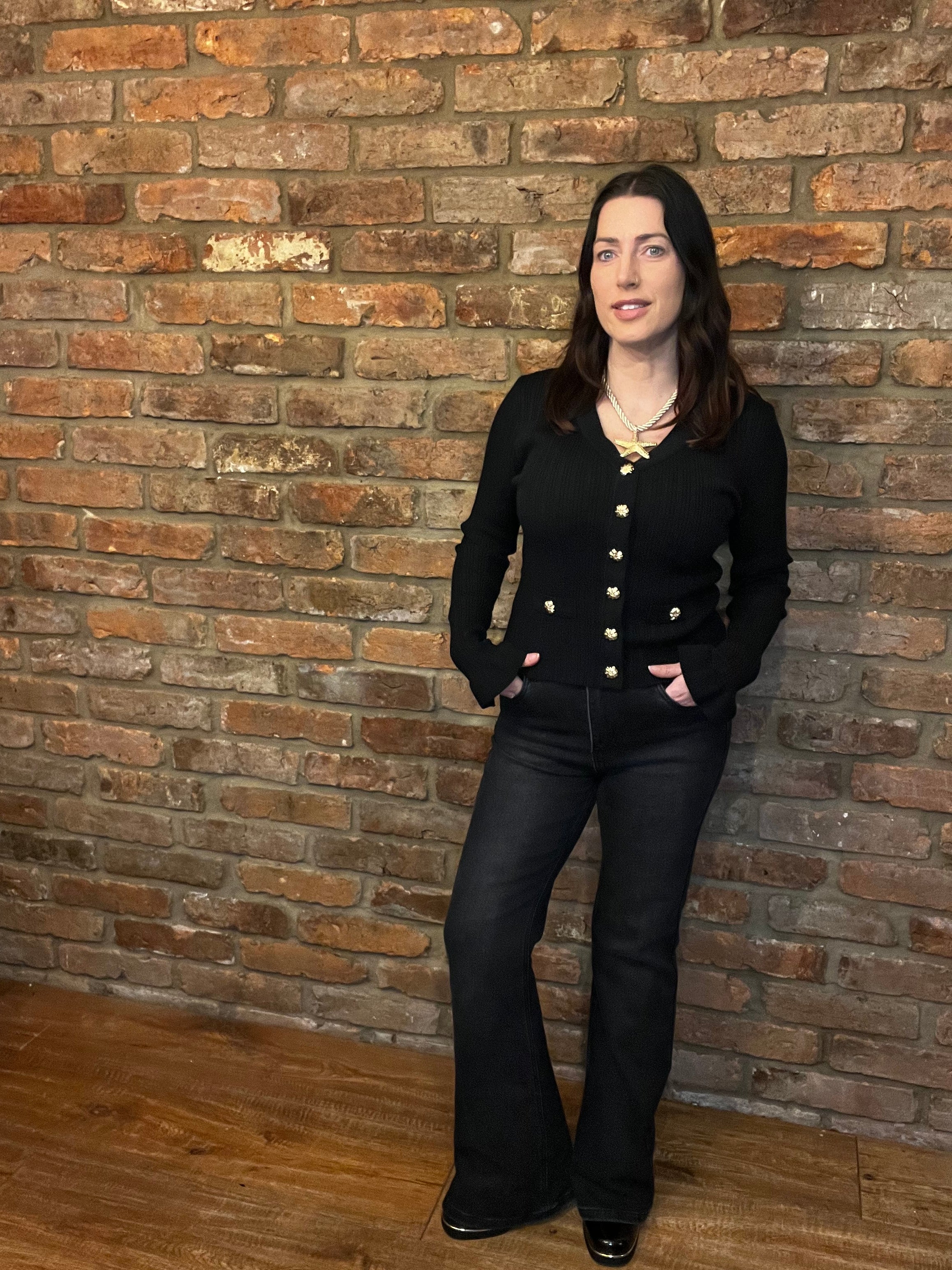 Black long sleeved knitted top with frill sleeves