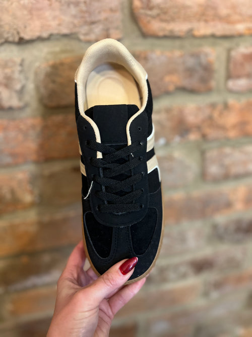 Black and cream trainers