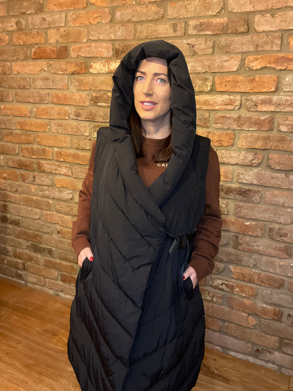 Sleeveless black hooded coat