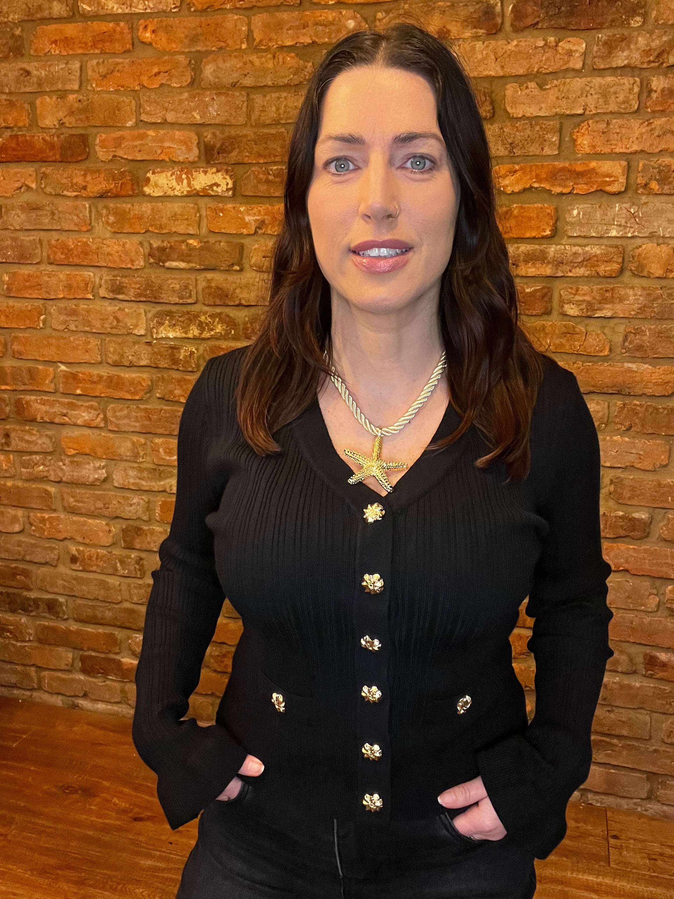 Black long sleeved knitted top with frill sleeves