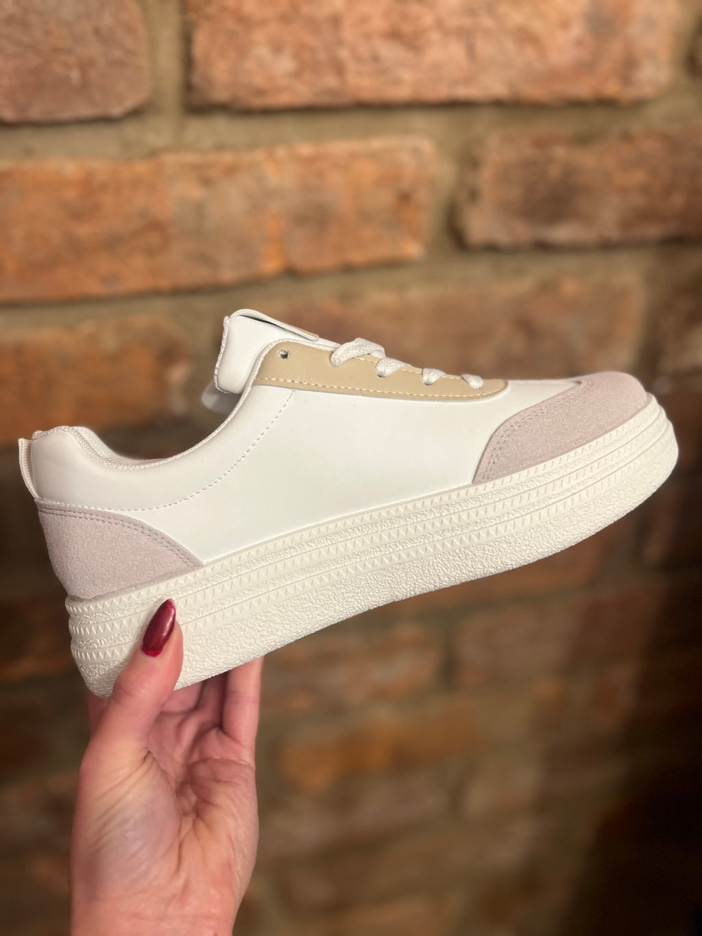 White trainers with three green stripes