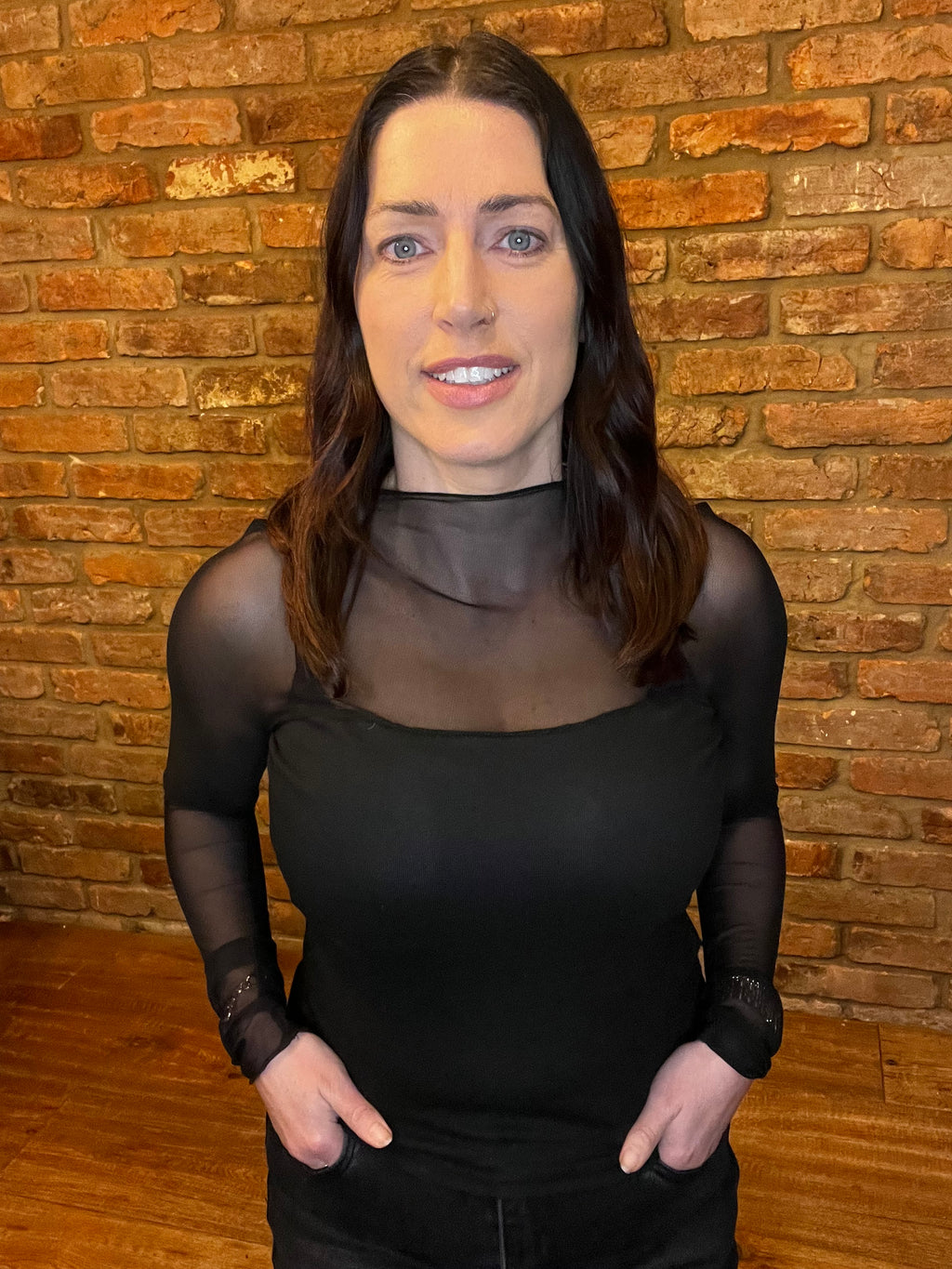 Black corset top with mesh sleeves